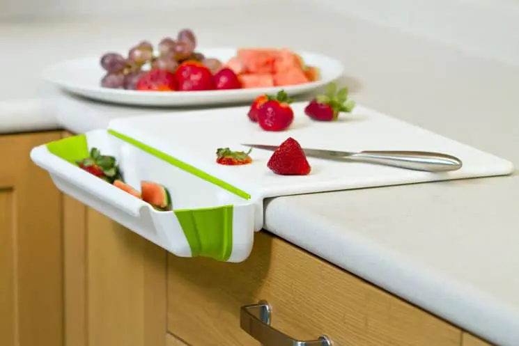 Counter edge poly cutting board with integrated removable bin